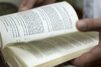 FILE PHOTO -- A chaplain looks through his bible prior to Catholic mass at Camp Lemonnier, Djibouti, Mar. 28, 2015. (U.S. Air Force/ Staff Sgt. Kevin Iinuma)