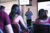 Pete Diaz, the family readiness officer of 9th Communication Battalion, addresses Marines and their families about available resources during a family new join brief at Camp Pendleton, Calif.